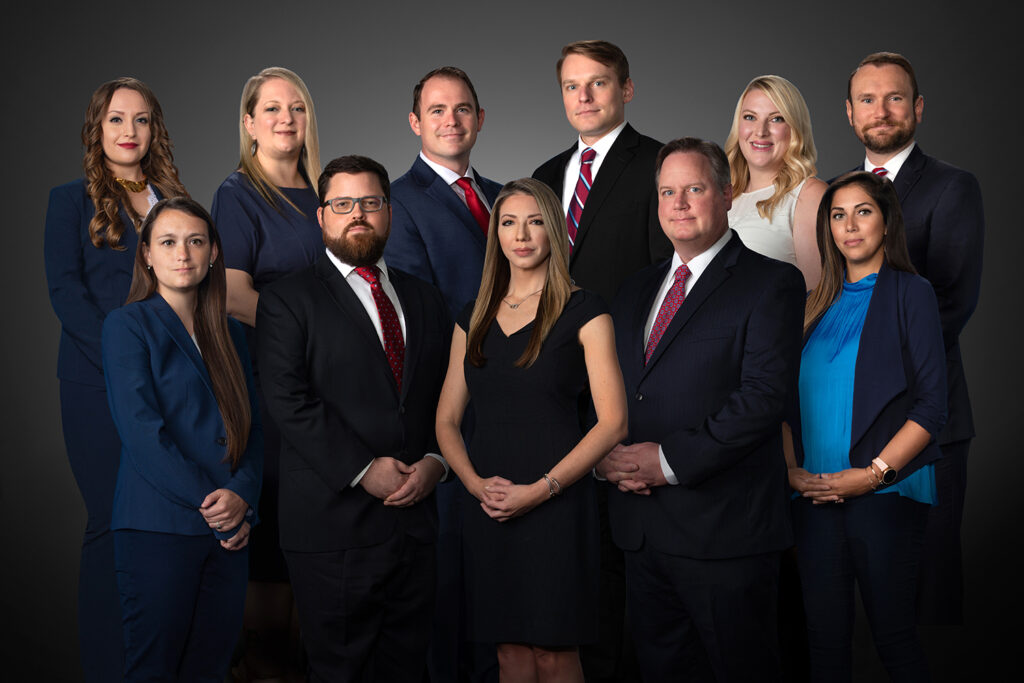 Composite group portrait of a professional team in business attire arranged together on a neutral studio background.