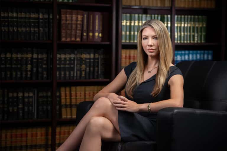Bespoke environmental executive portrait in a law-library setting, included with on-location team headshot sessions.
