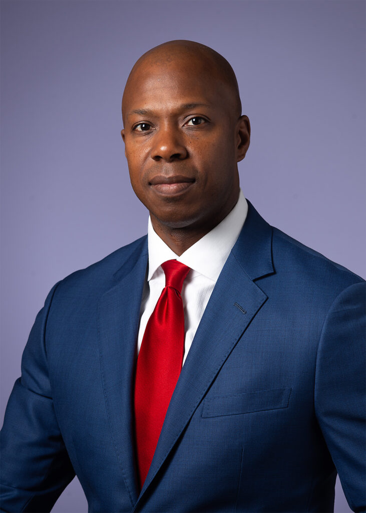 Corporate executive headshot before retouching showing natural skin texture, facial details, and original studio lighting prior to professional retouching