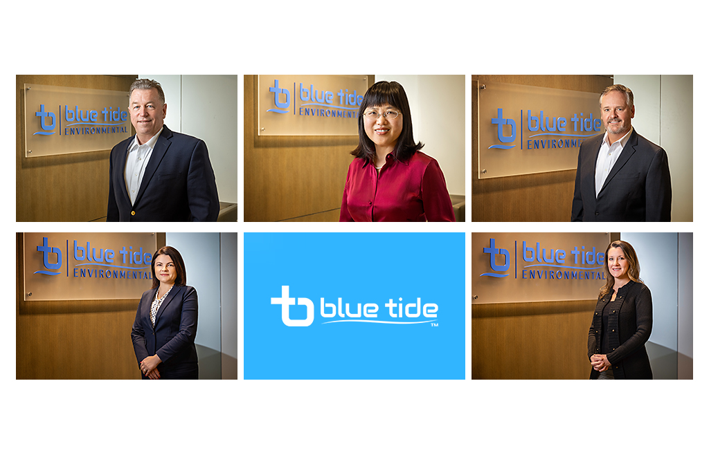 Professional corporate headshots for Blue Tide Environmental leadership team photographed in a modern office lobby with company branding and logo signage in the background