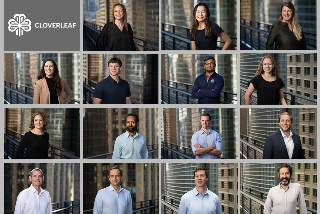 Team headshots photographed on a downtown Houston office building rooftop, with city buildings forming the background behind each portrait.