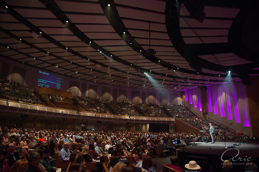Wide photograph of a speaker on stage addressing a large audience during the Oil & Gas Awards gala in a theater-style venue.