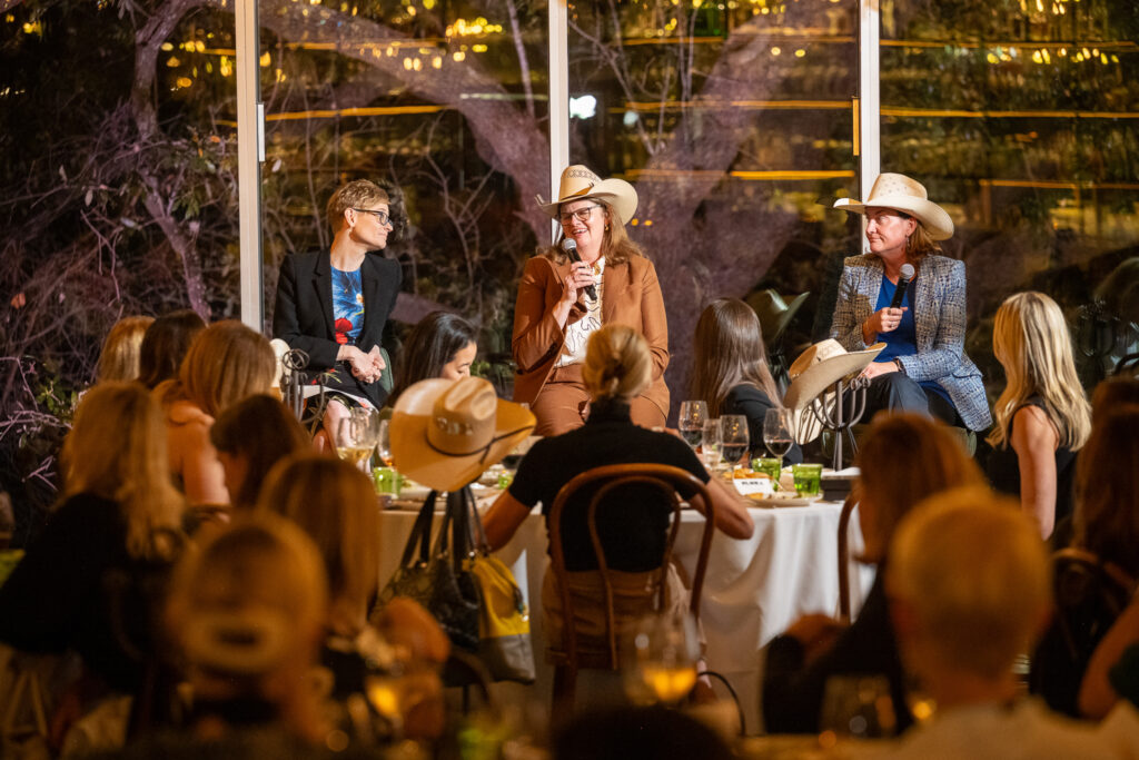 Speakers at The Hawthorn Club networking meeting at Flora during 2026 CERAWeek, seated in front of a live audience.